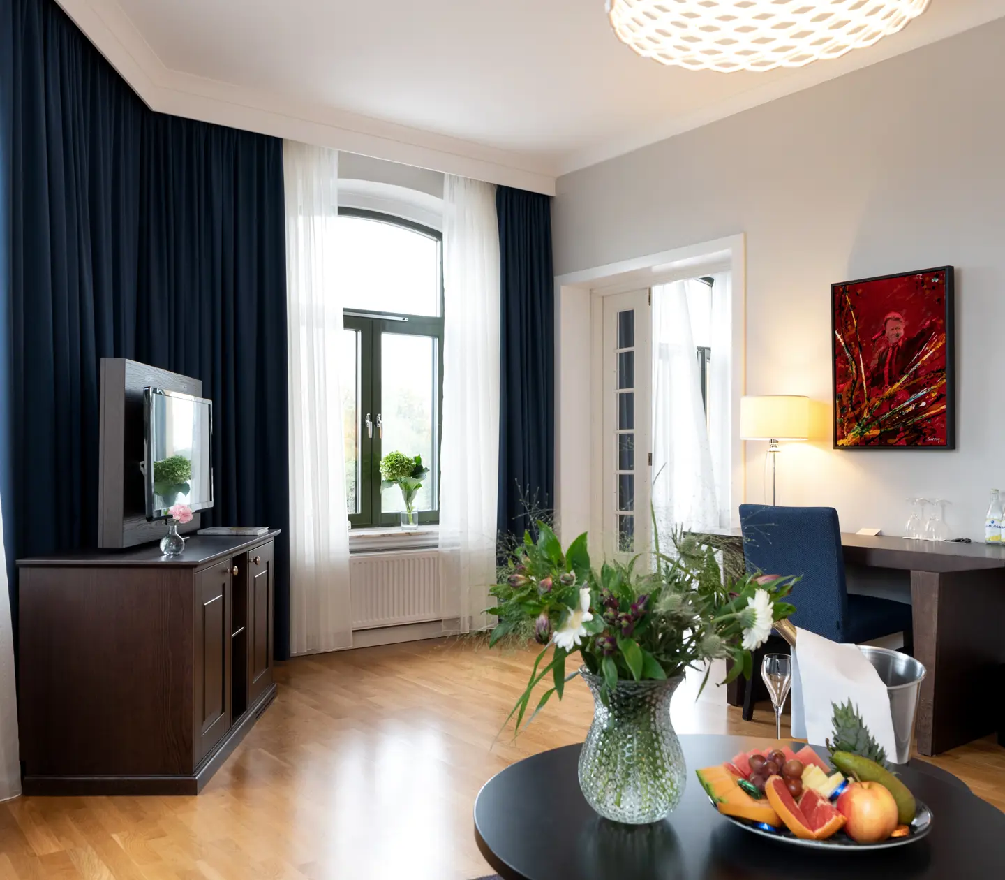 Bright suite with desk, TV and large windows