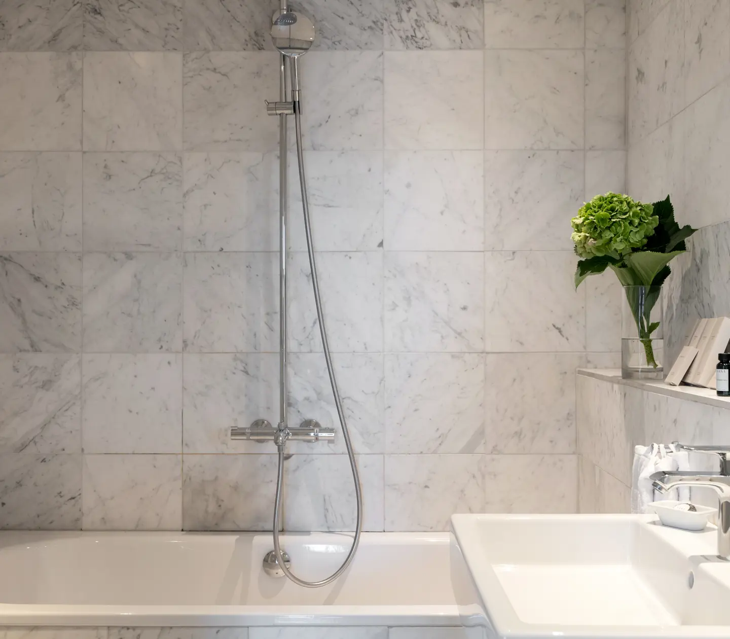 Bright bathroom with sink, shower and bathtub
