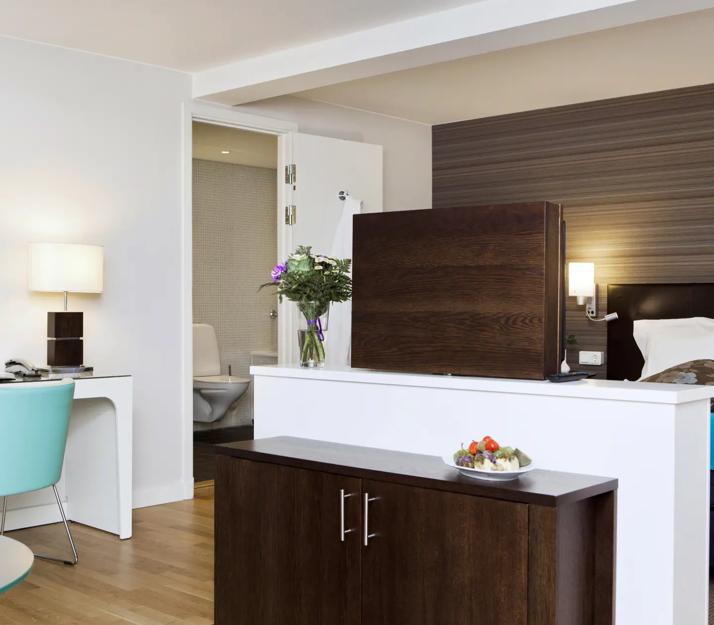 Suite with bed, desk and TV