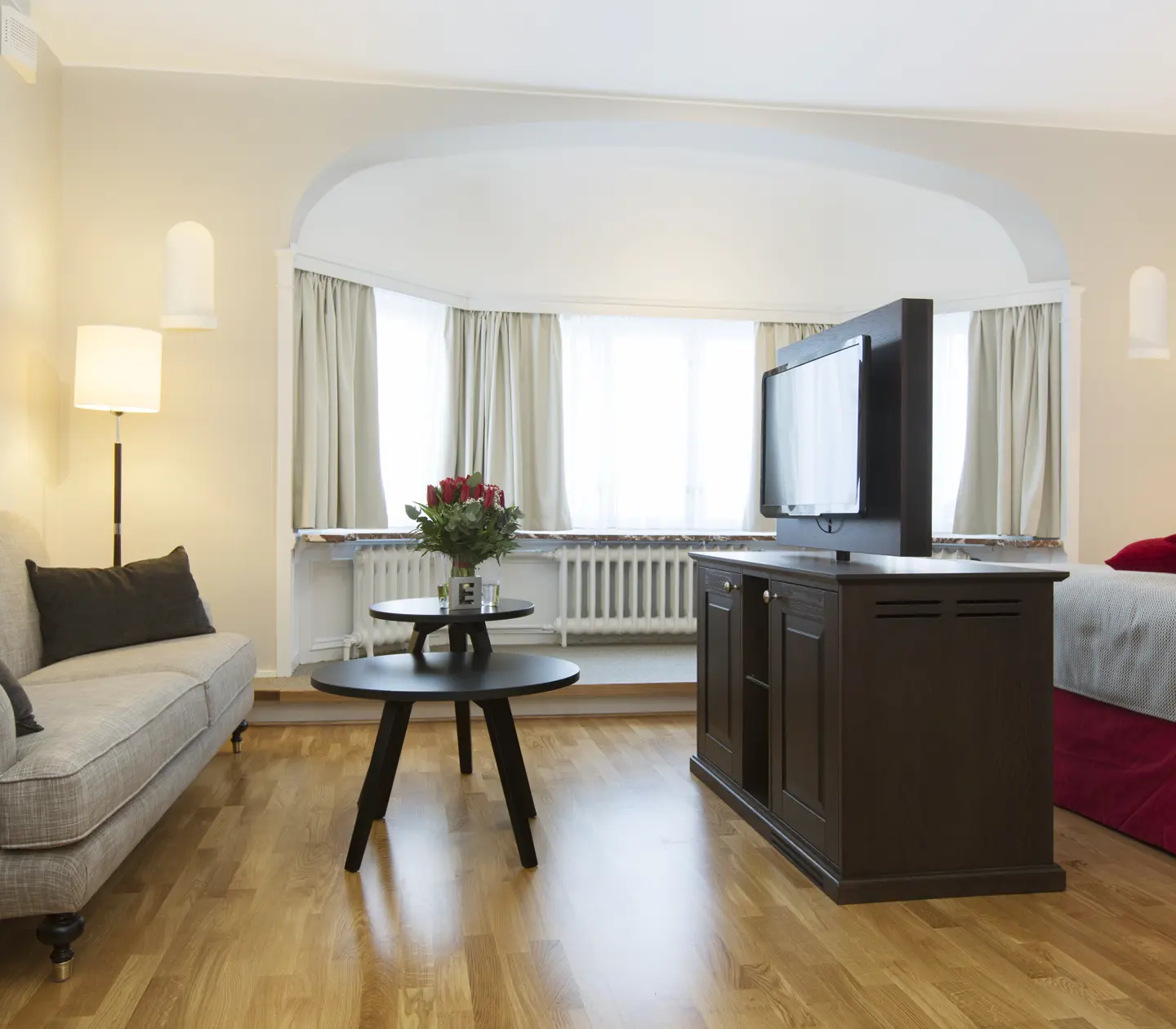 Bright suite with sofa, bay window and TV