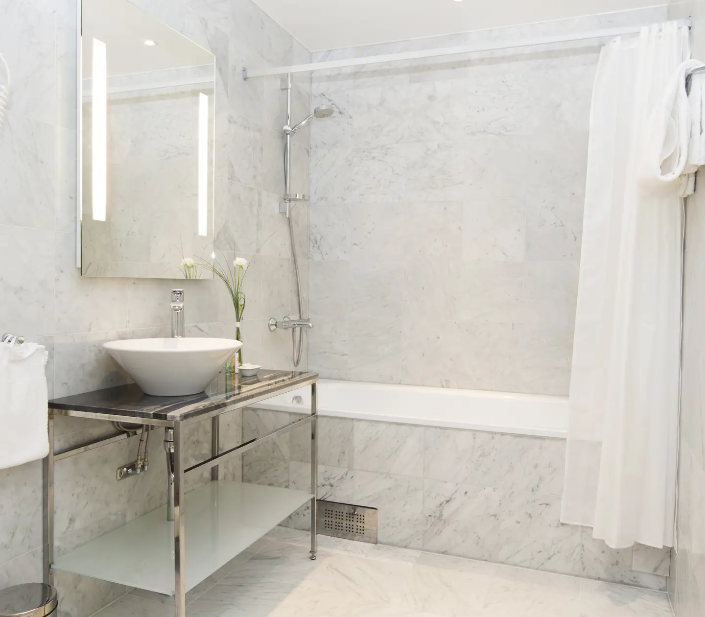 Bright bathroom with sink, mirror and bathtub