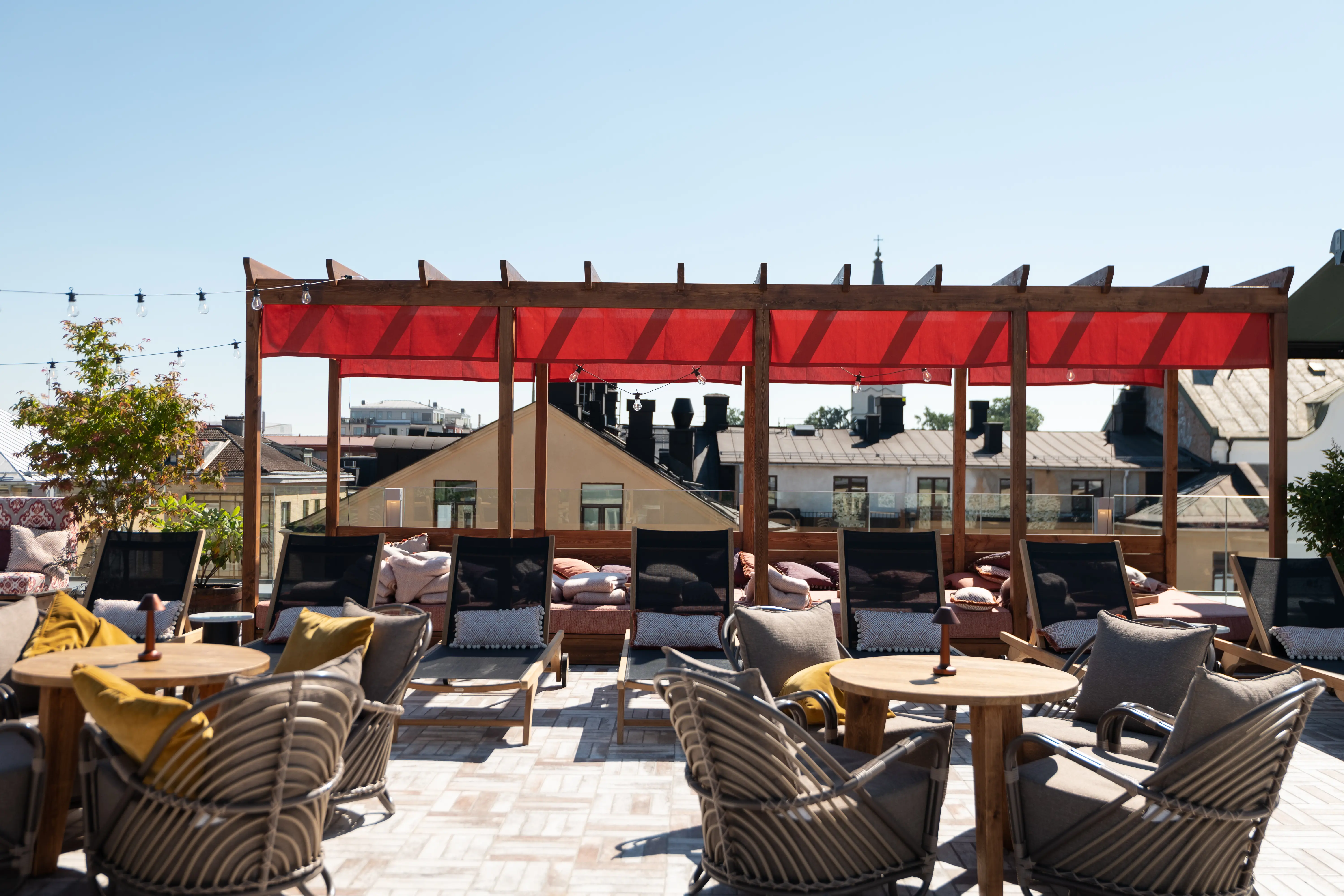 Roof terrace with sunbeds and eaves in the background