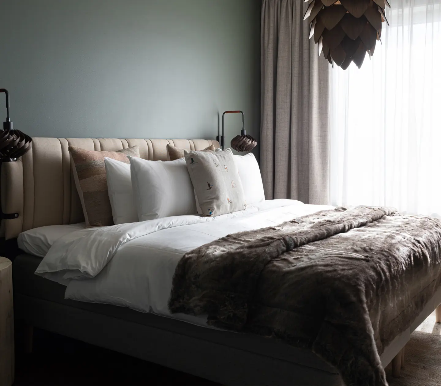 Nicely made hotel bed in a Deluxe room.