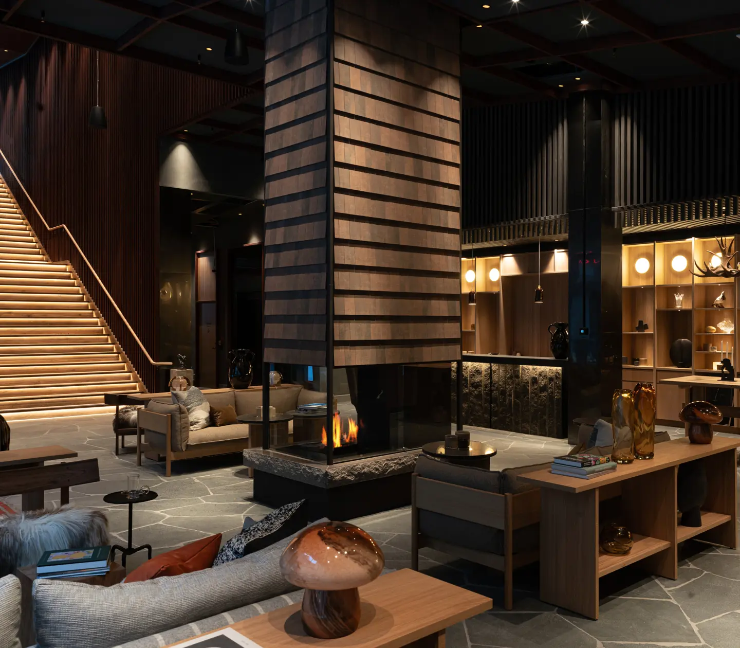 Lobby with reception desk, large fireplace, and seating.