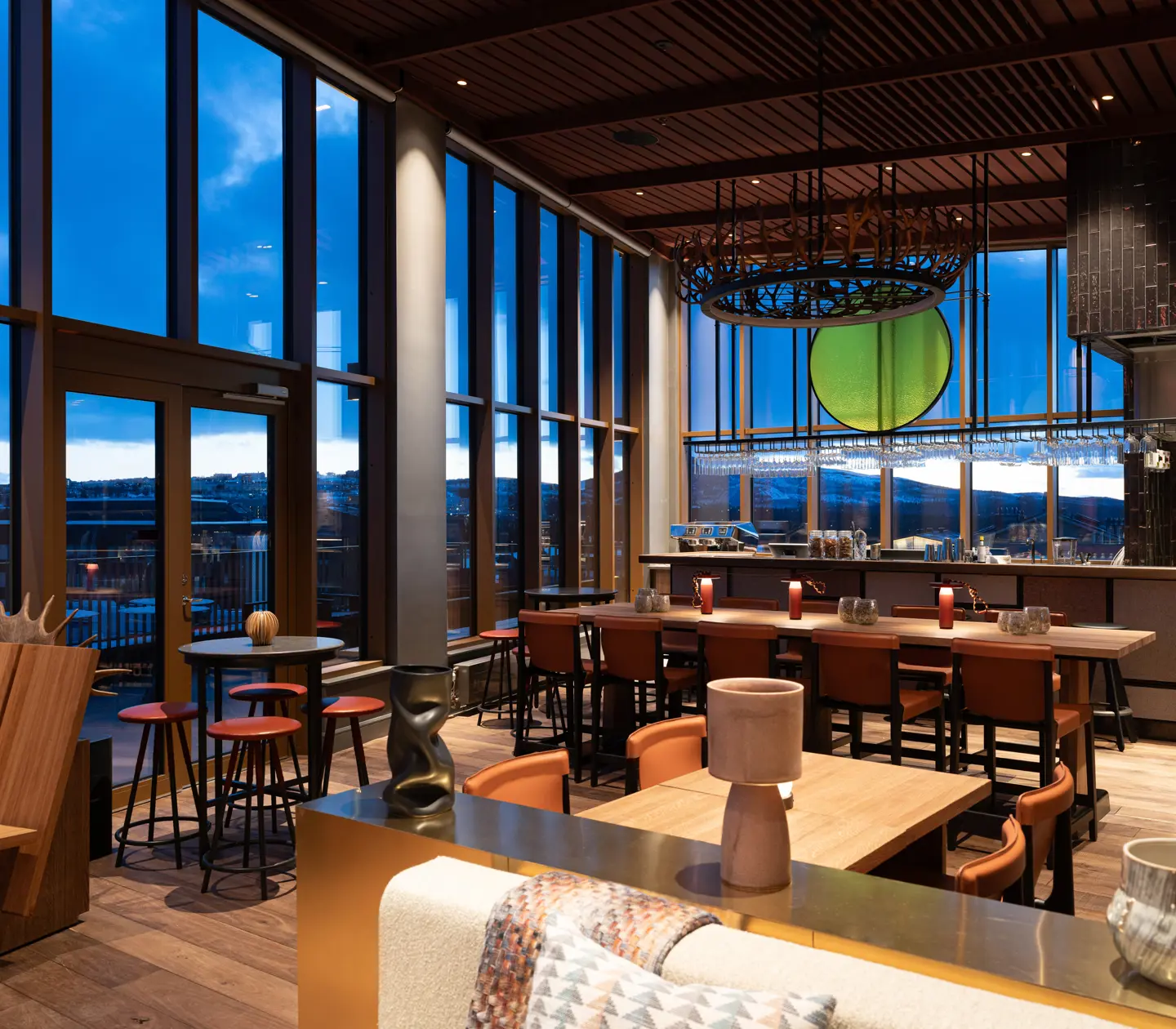 Panoramic view of Rooftop By Fe at dusk, overlooking the mountains.