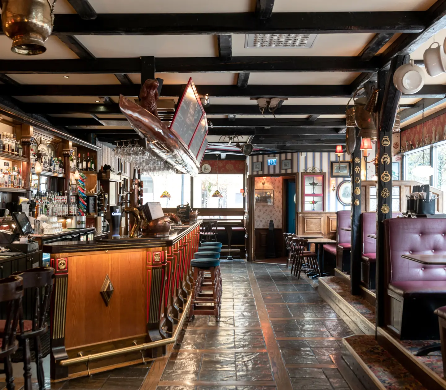 Pub environment with seating, bar and bottles