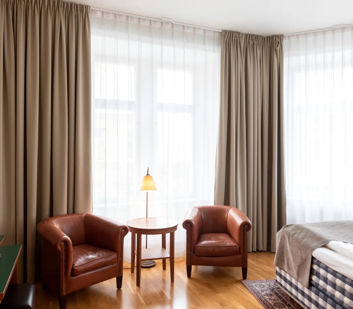 Hotel room with Hästens bed, leather armchairs and window
