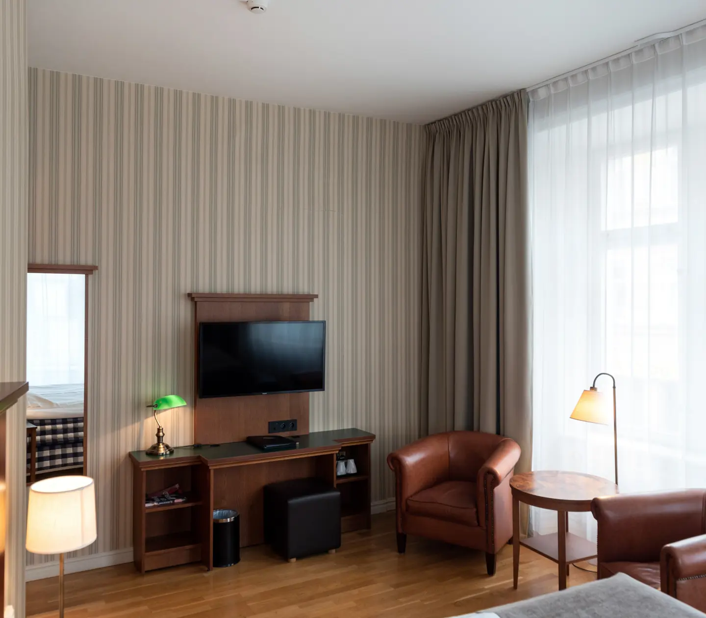 Hotel rooms with desks, leather armchairs and windows