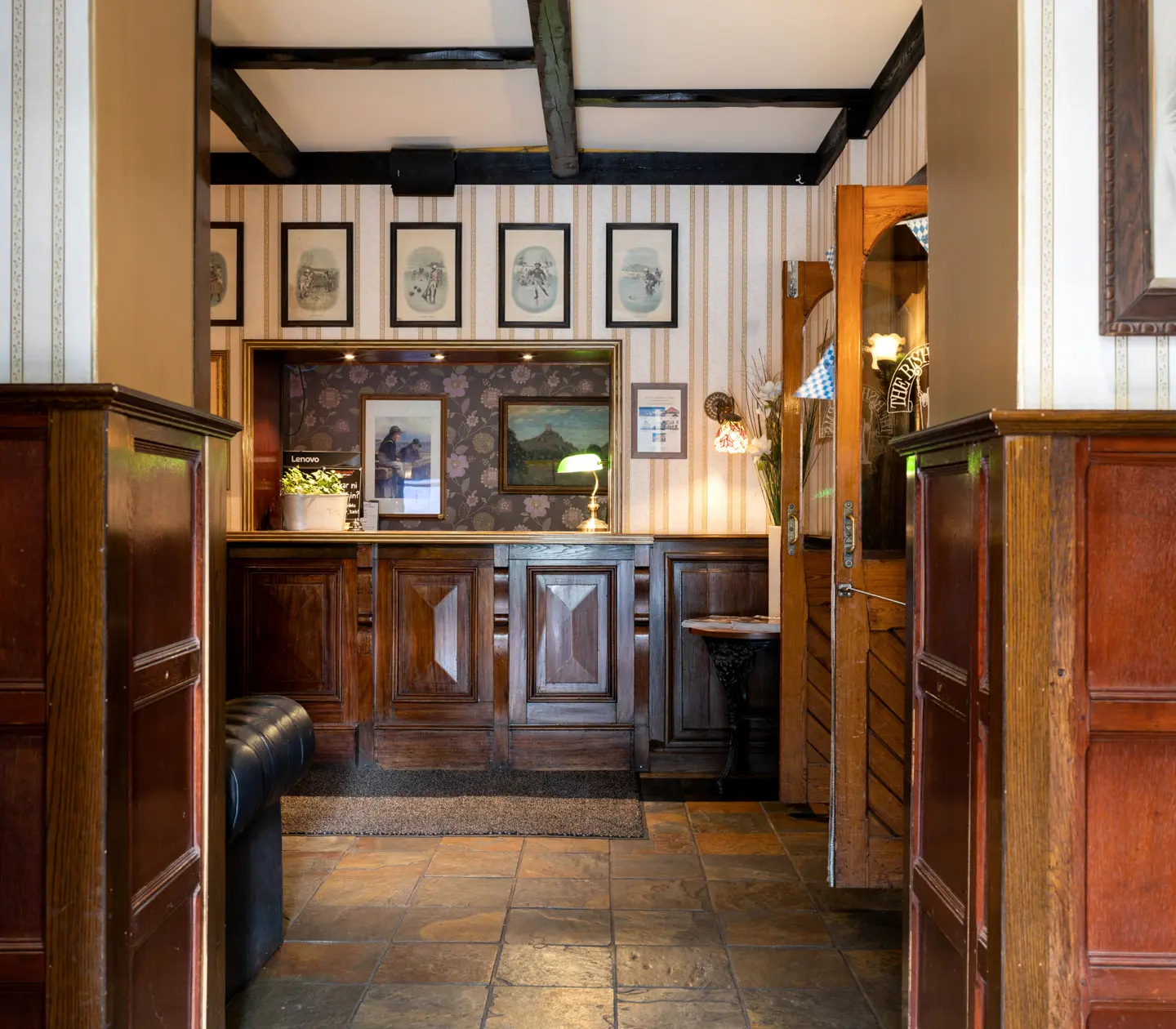 Reception desk with paintings and wooden beams in the ceiling