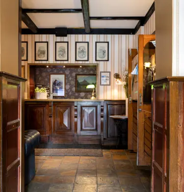 Reception desk with paintings and wooden beams in the ceiling