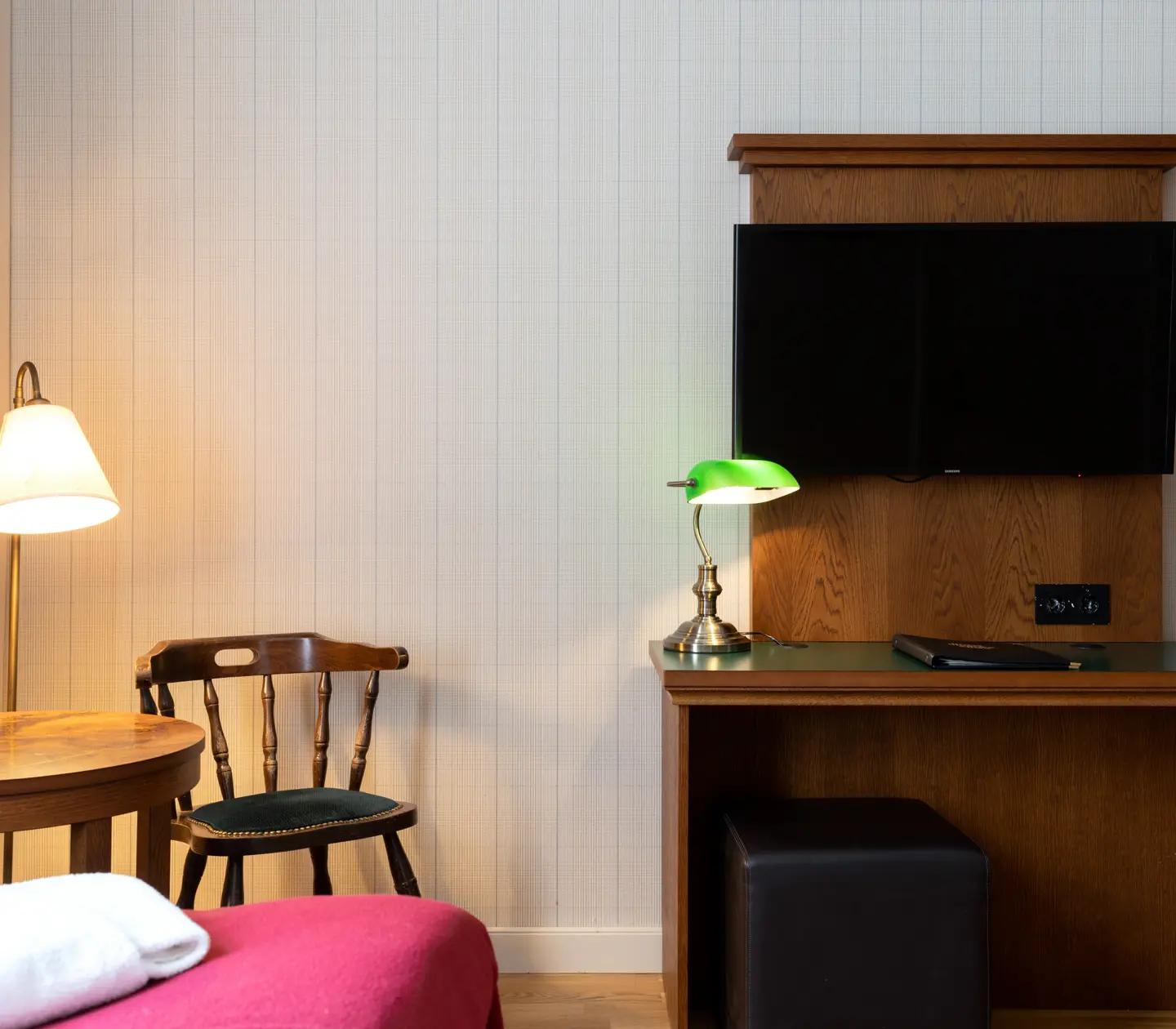 Cozy hotel room with chair, desk and TV