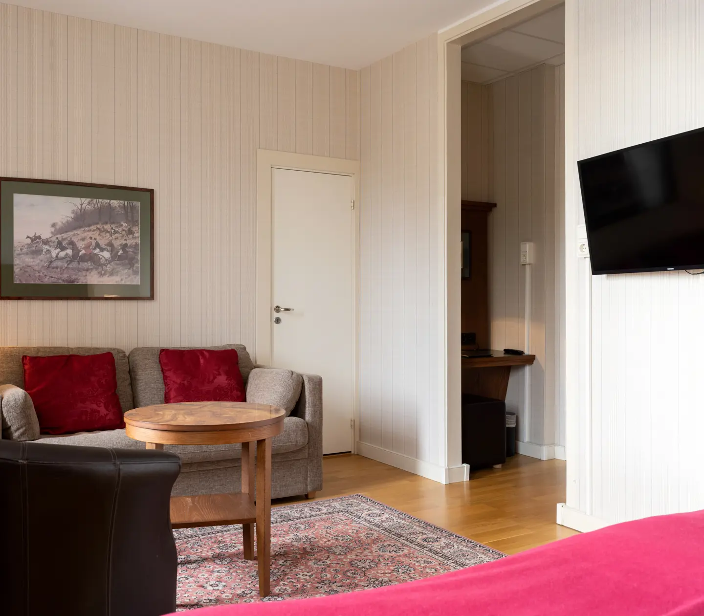 Cozy hotel room with sofa, TV and blackboard