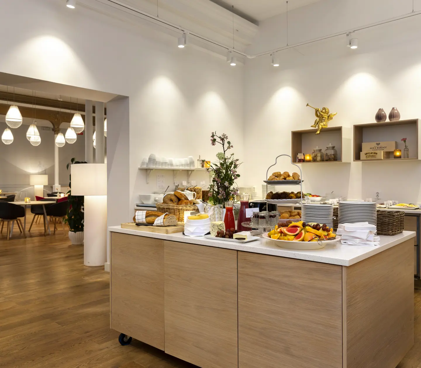 Breakfast buffet laid out on a table with food groups in the background