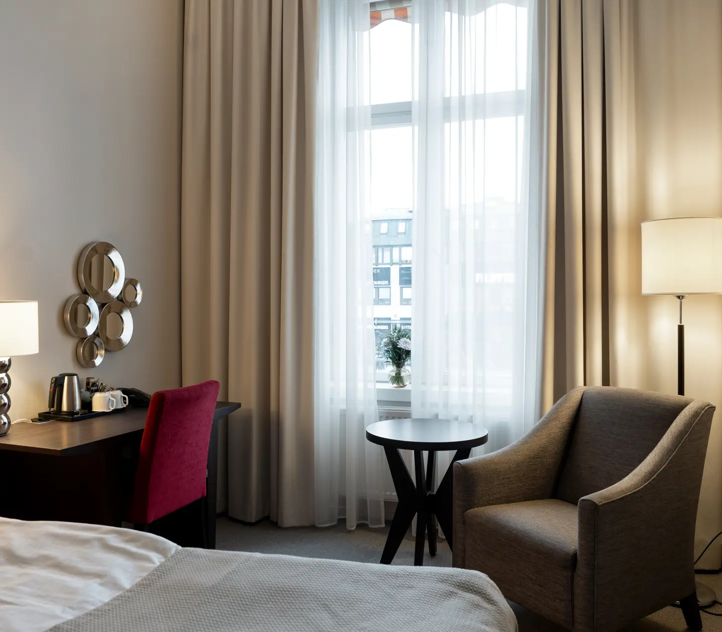 Hotel room with double bed, desk and window