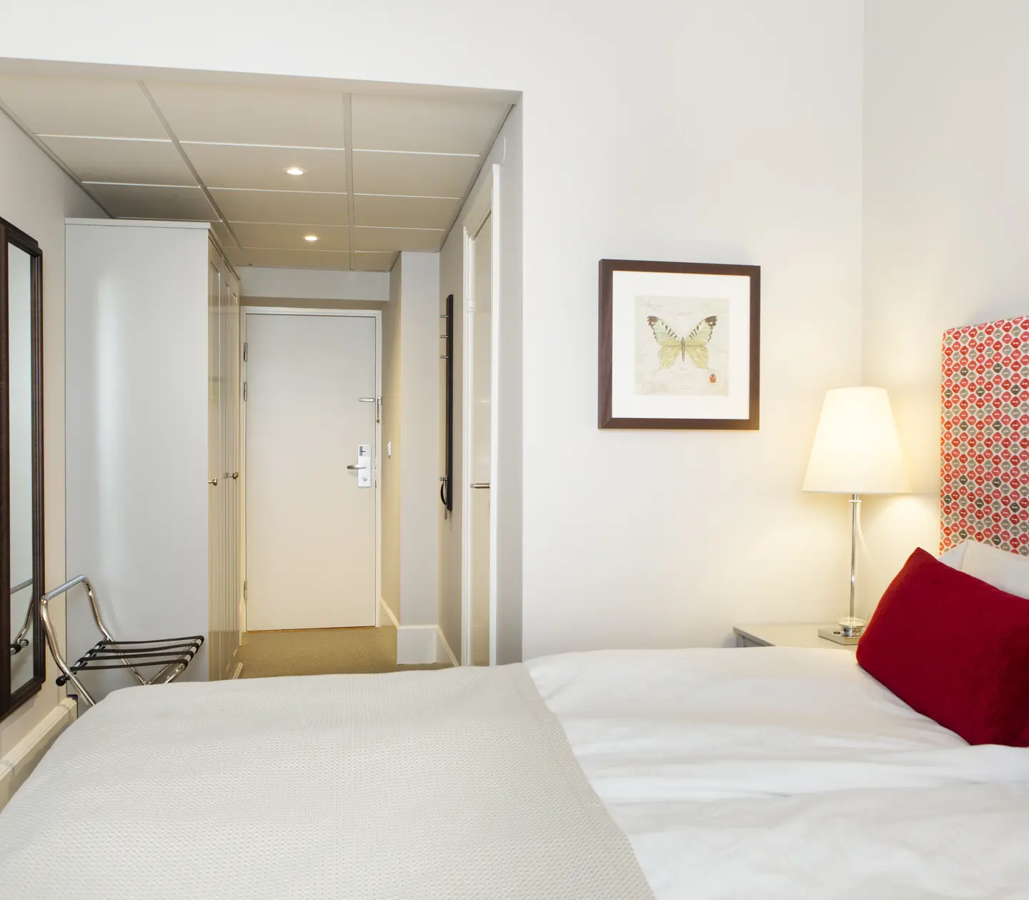 Hotel room with double bed, mirror and blackboard