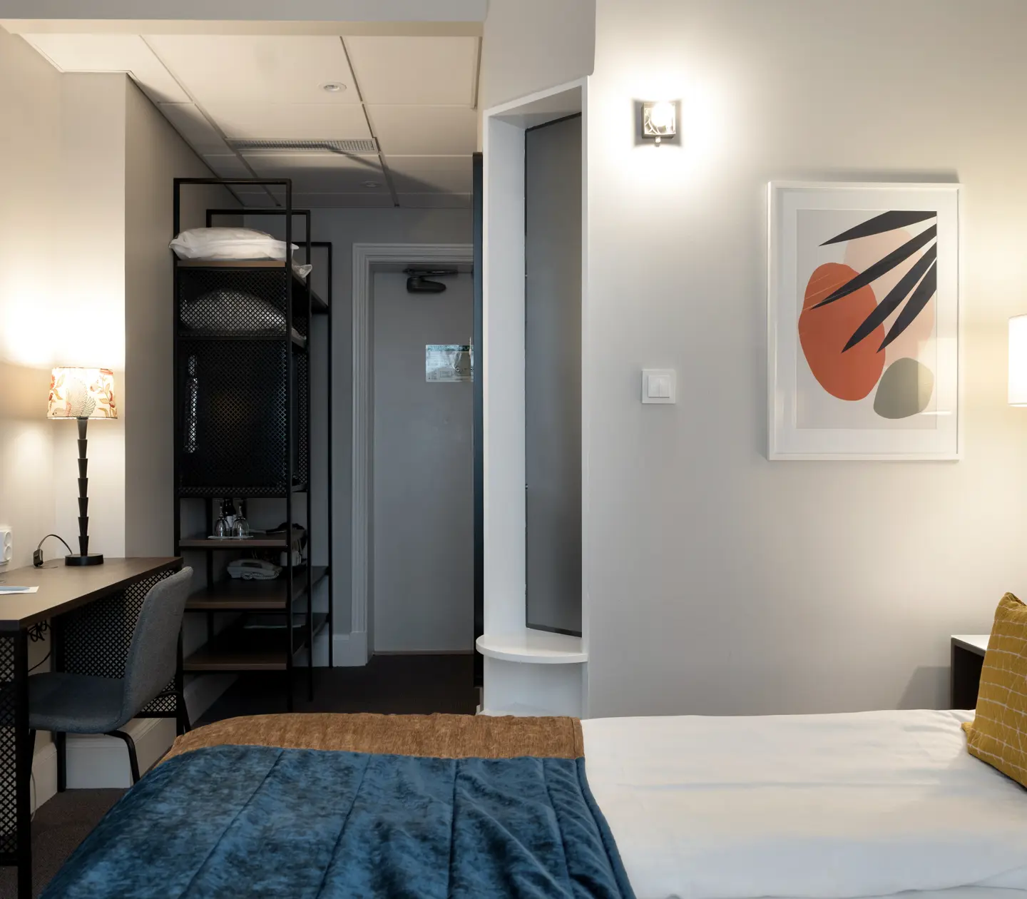 Hotel room with double bed, desk and blackboard