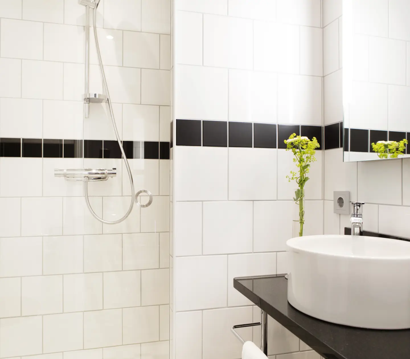 Bright bathroom with shower, sink and mirror