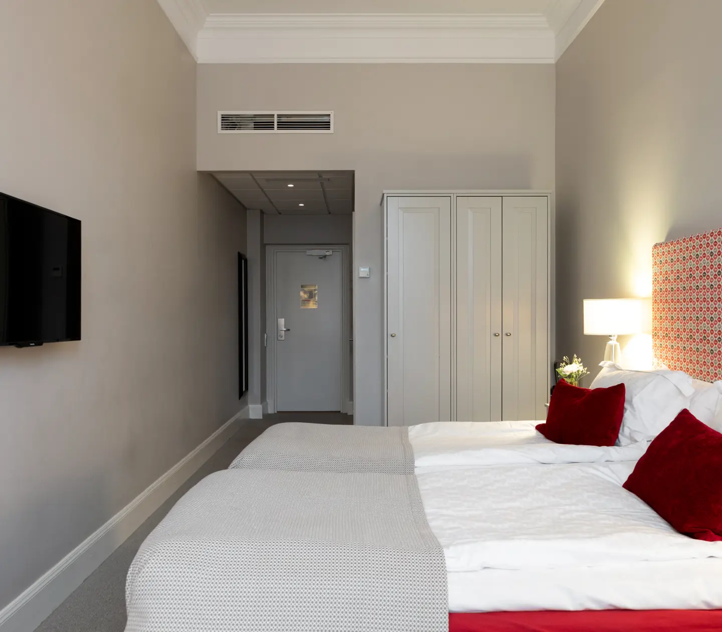Hotel room with double bed, wardrobe and TV
