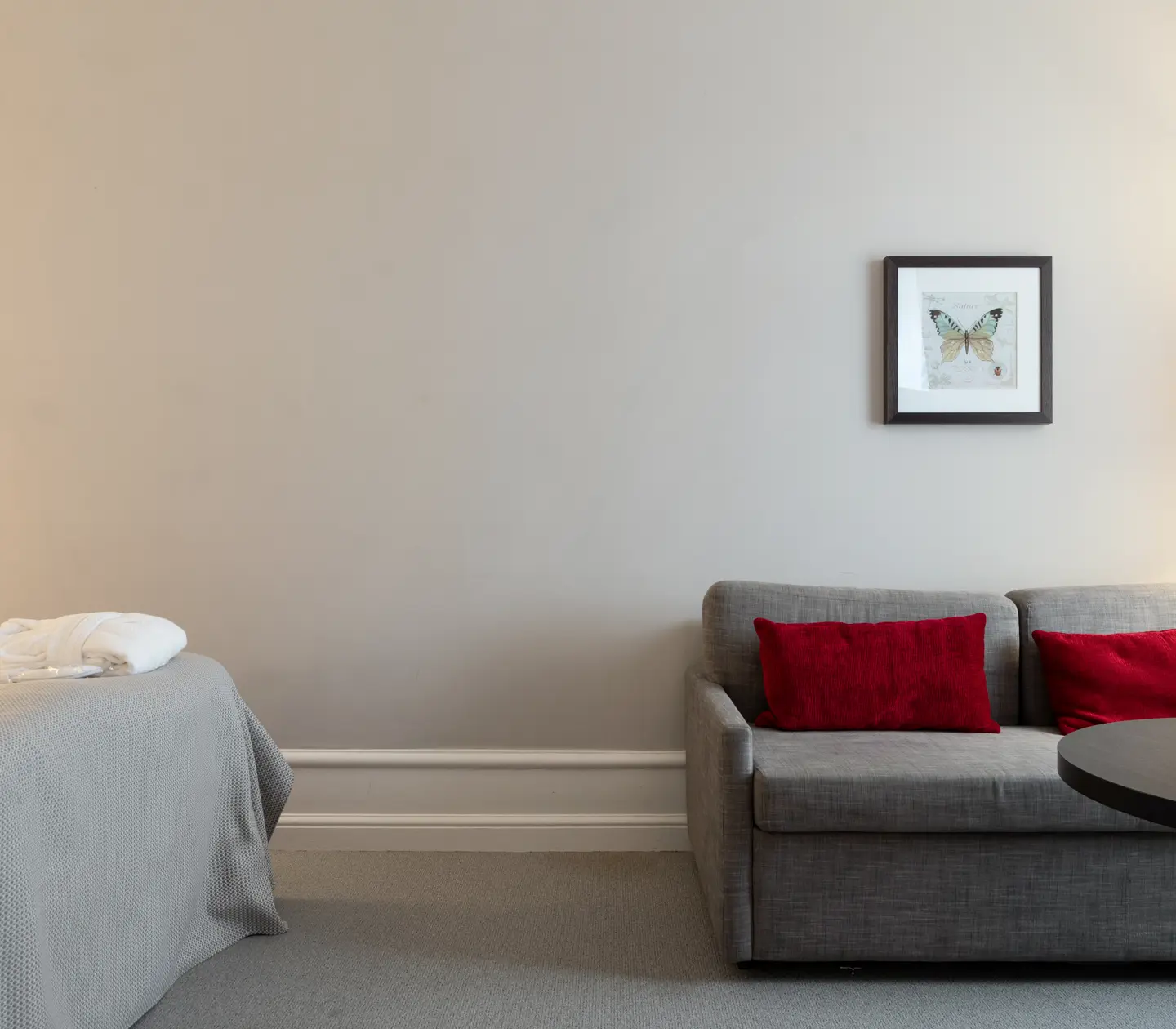 Hotel room with sofa, coffee table and blackboard