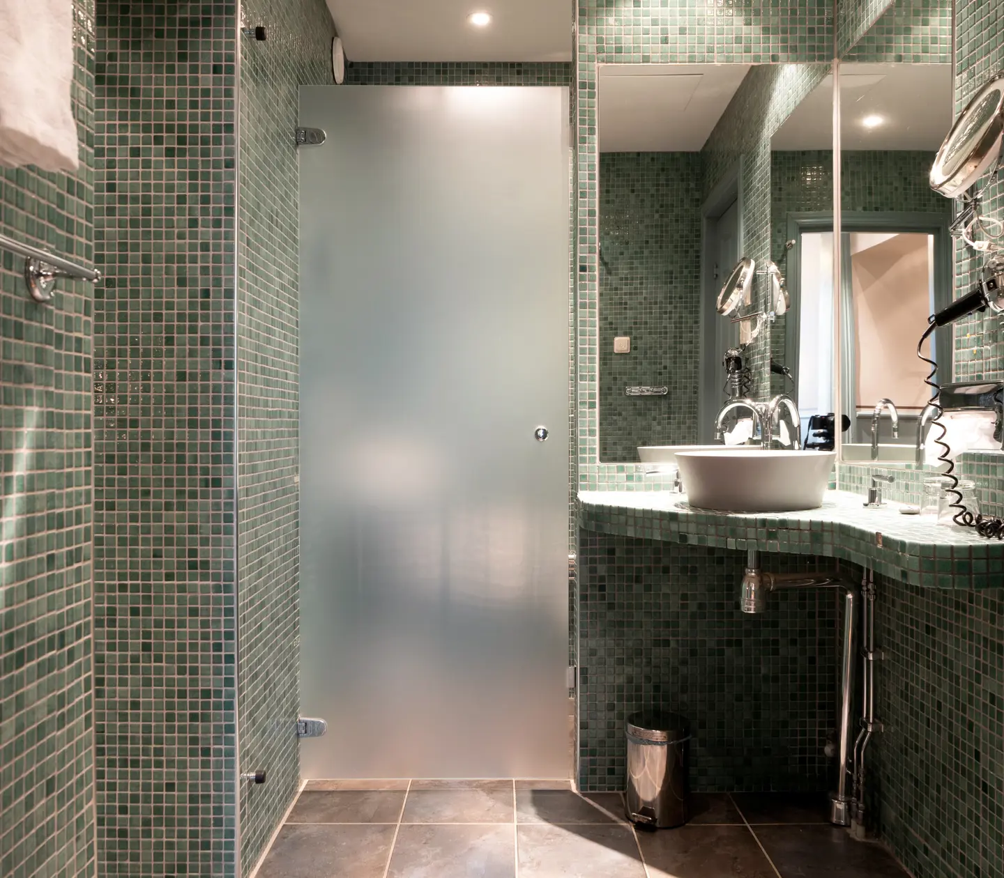 Green bathroom with sink, shower and mirror