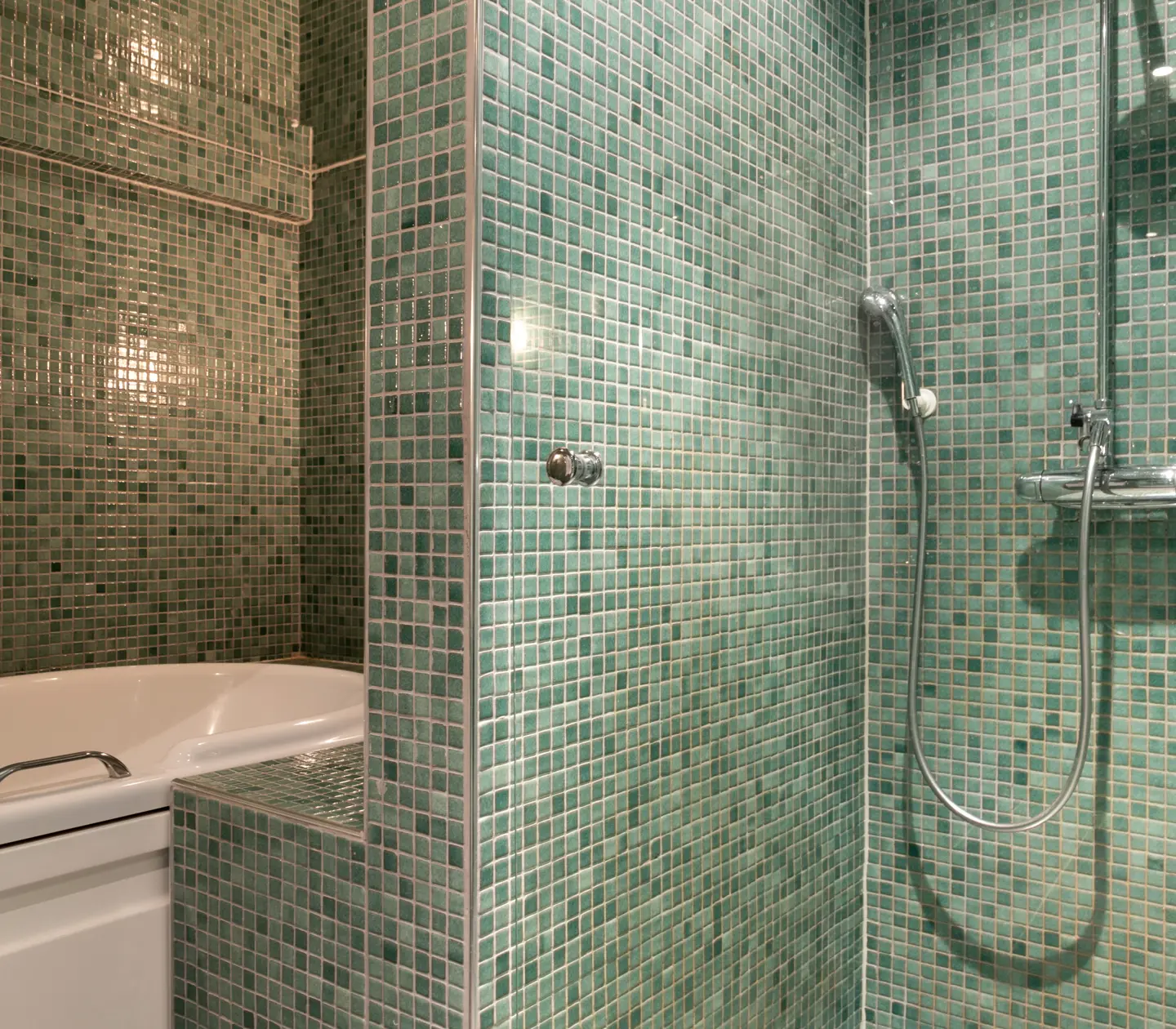 Green bathroom with bathtub and shower