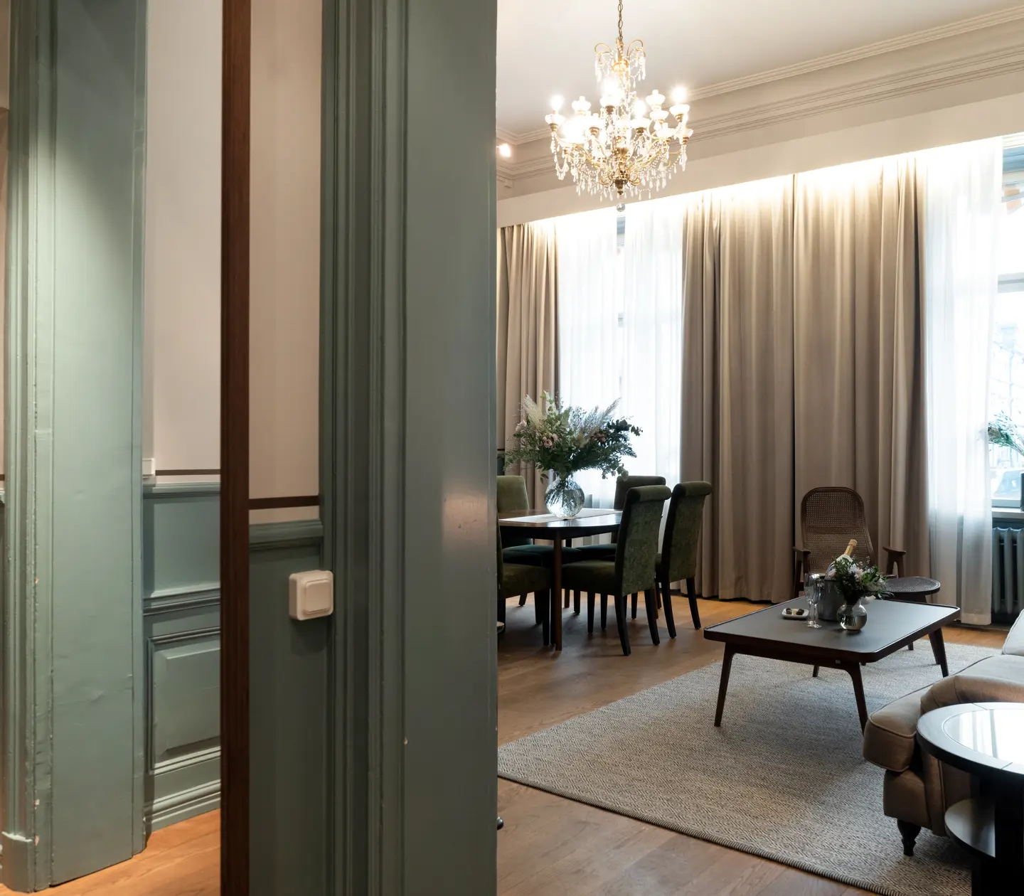 Cozy suite with dining table, sofa group and large windows
