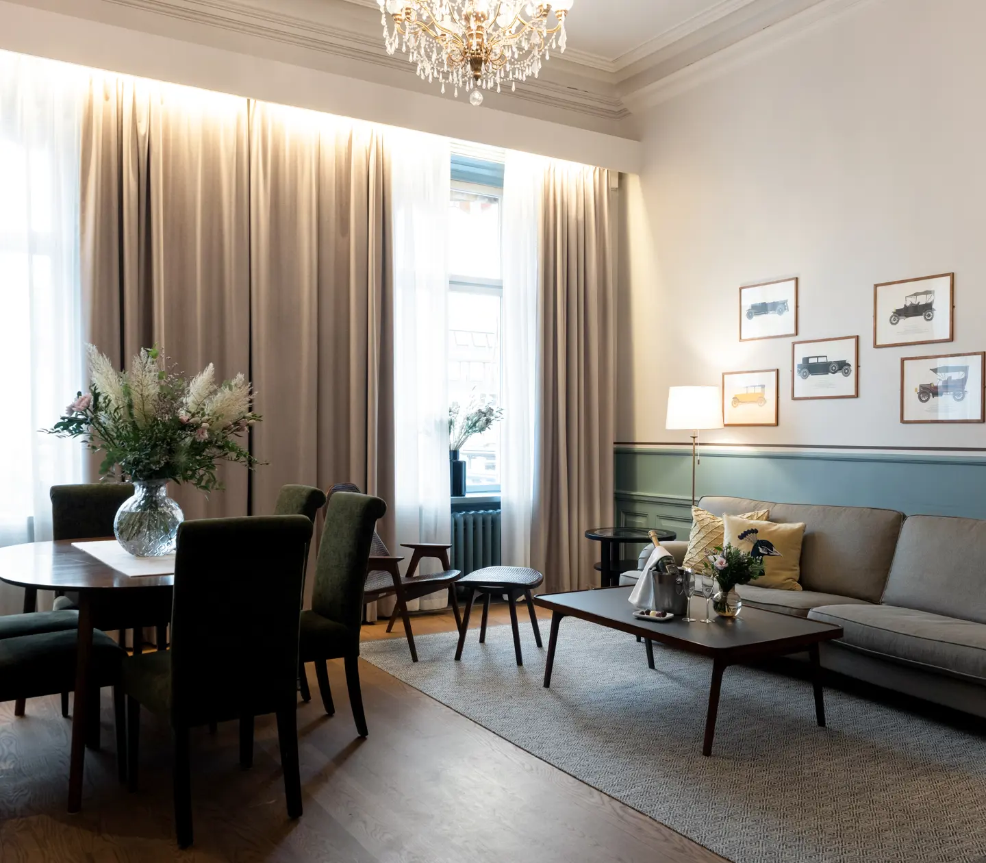 Cozy suite with dining table, sofa group and paintings