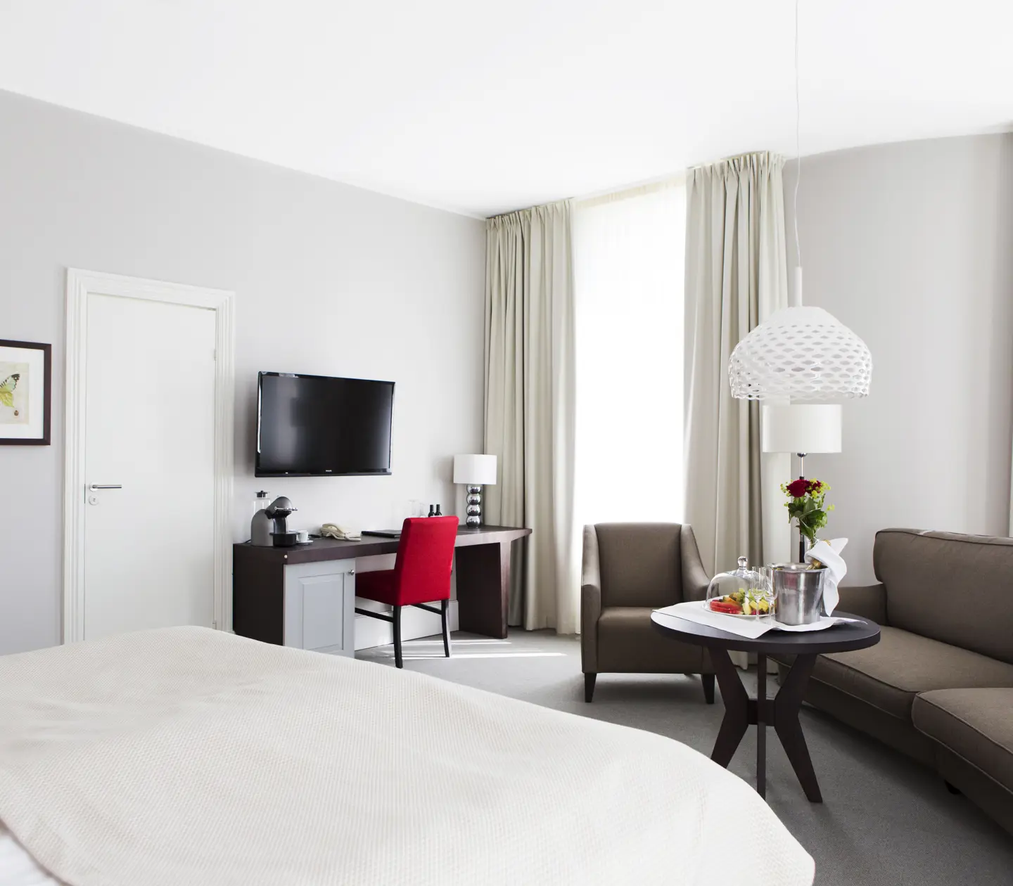Bright suite with sofa group, TV and window