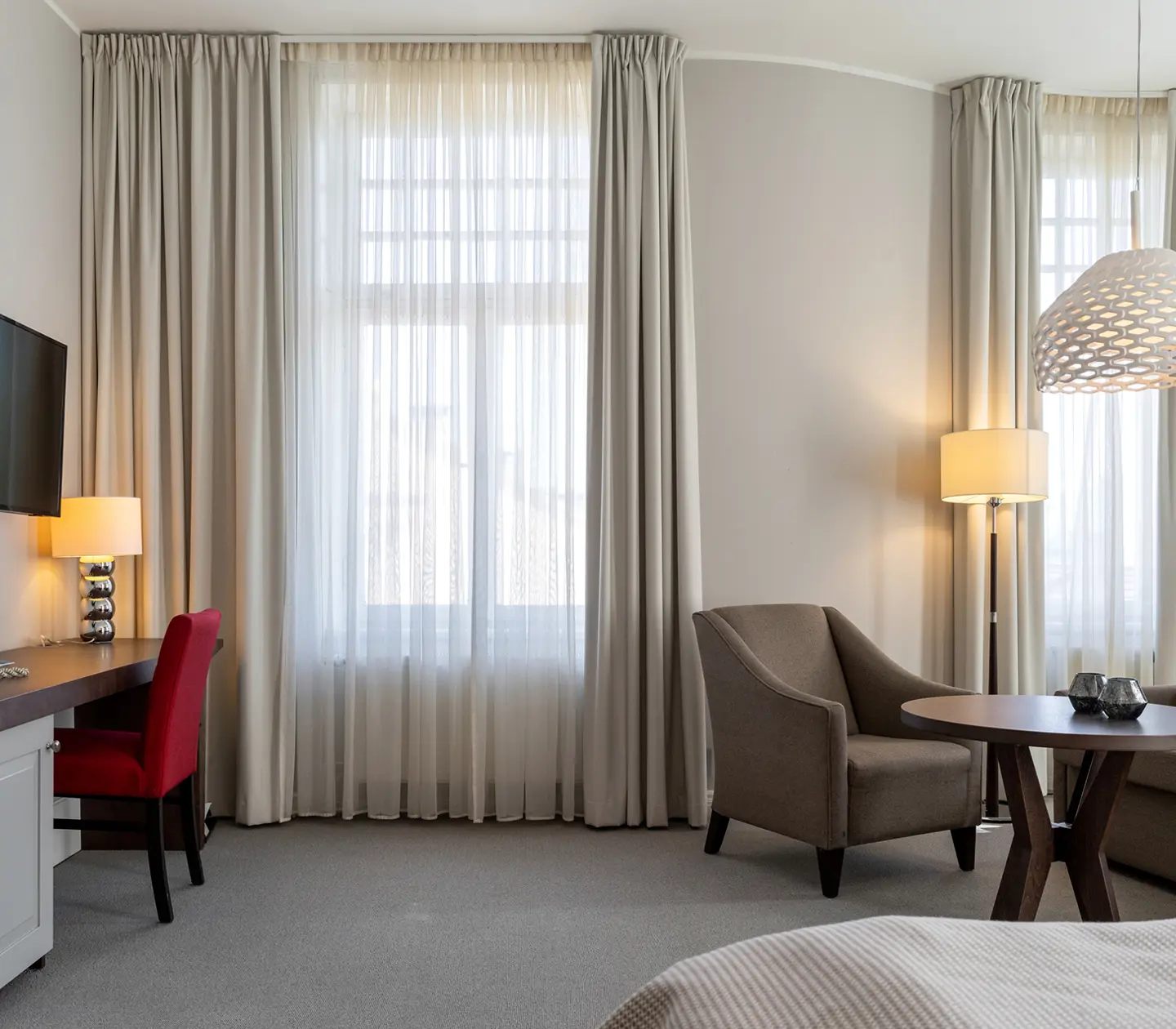 Bright suite with sofa group, desk and window