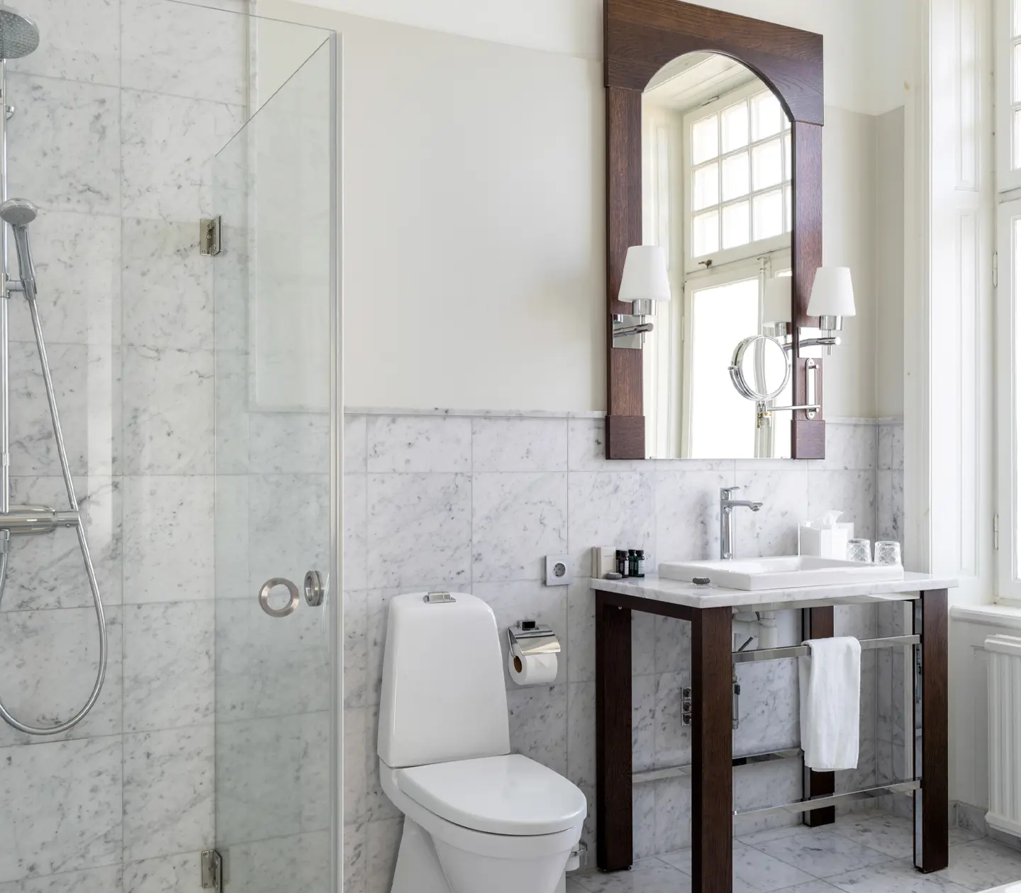 Bright bathroom with toilet, shower and window
