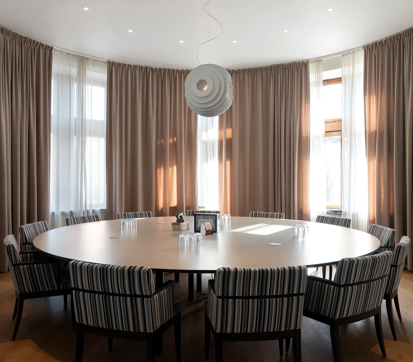 Round conference room with round table and large windows