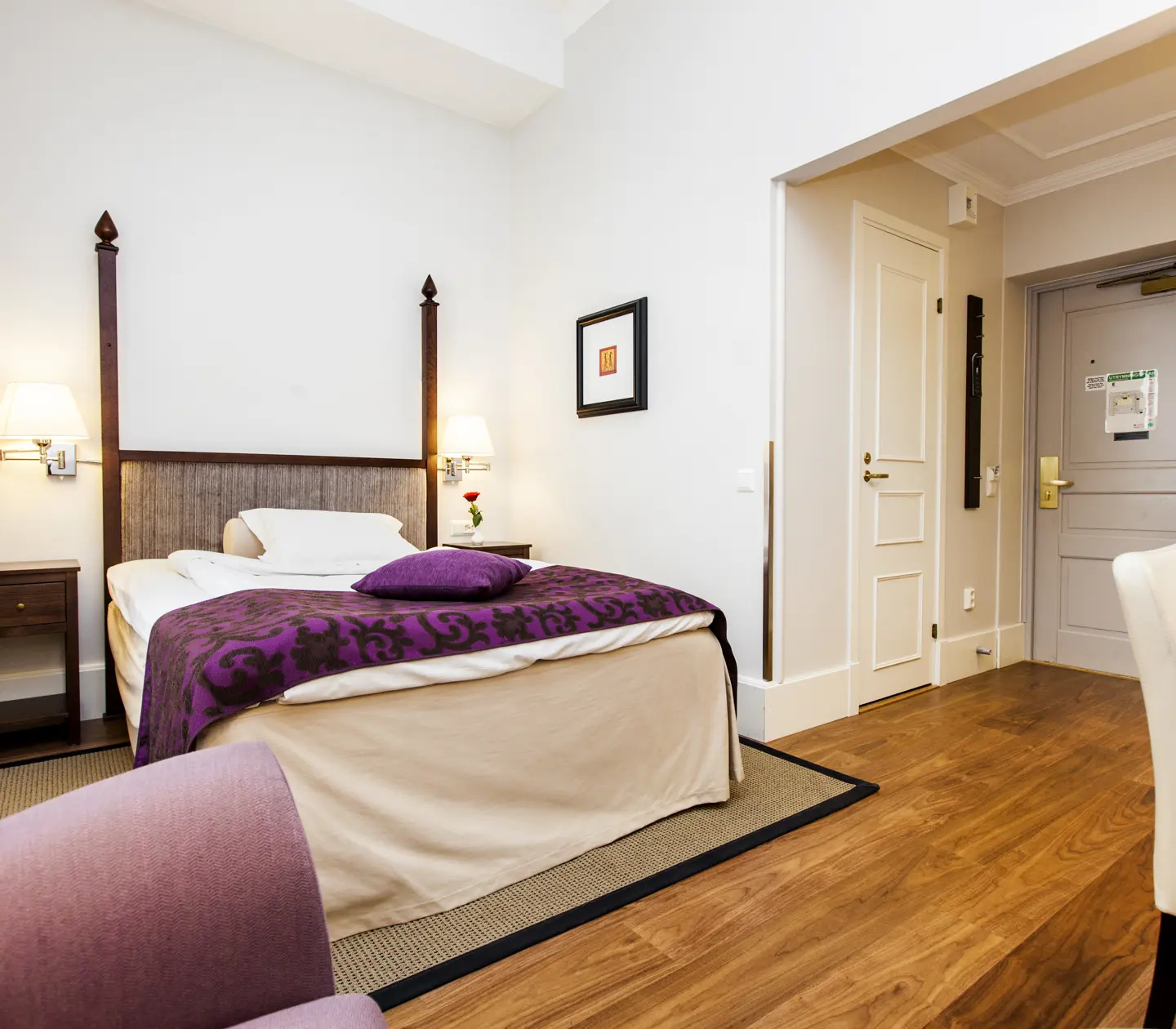 Bright hotel room with desk, single bed and blackboard