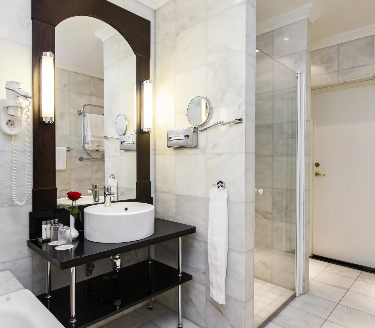 Bright bathroom with bathtub, shower and sink