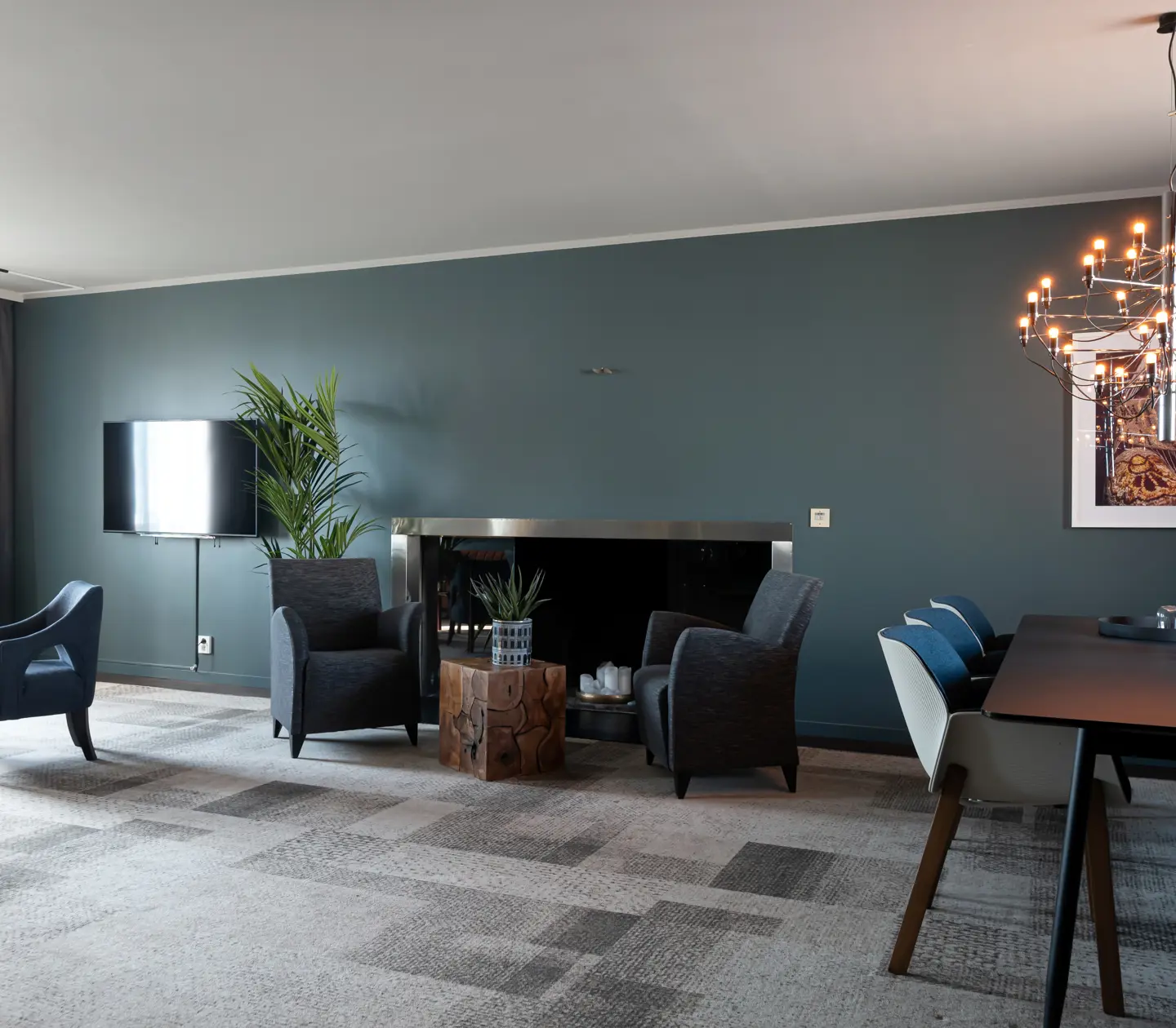 Blue suite with fireplace, armchairs and dining table