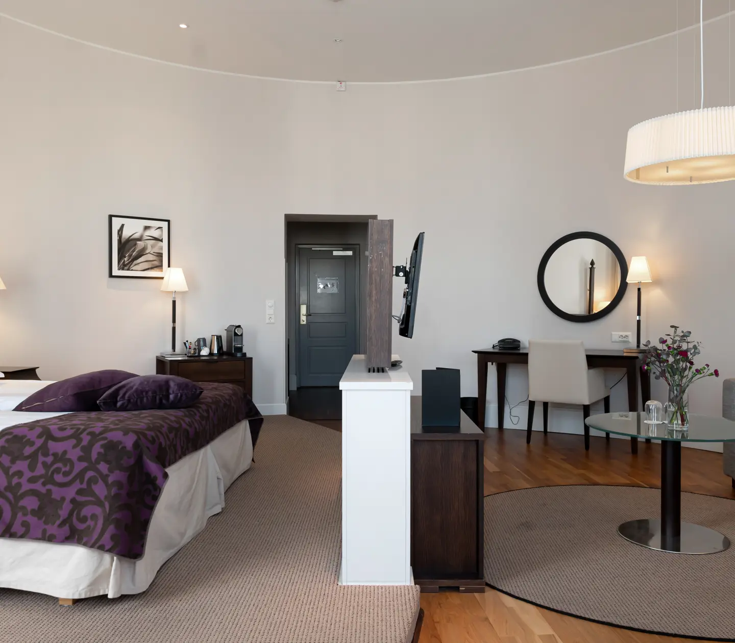 Bright suite with desk, sofa group and double bed
