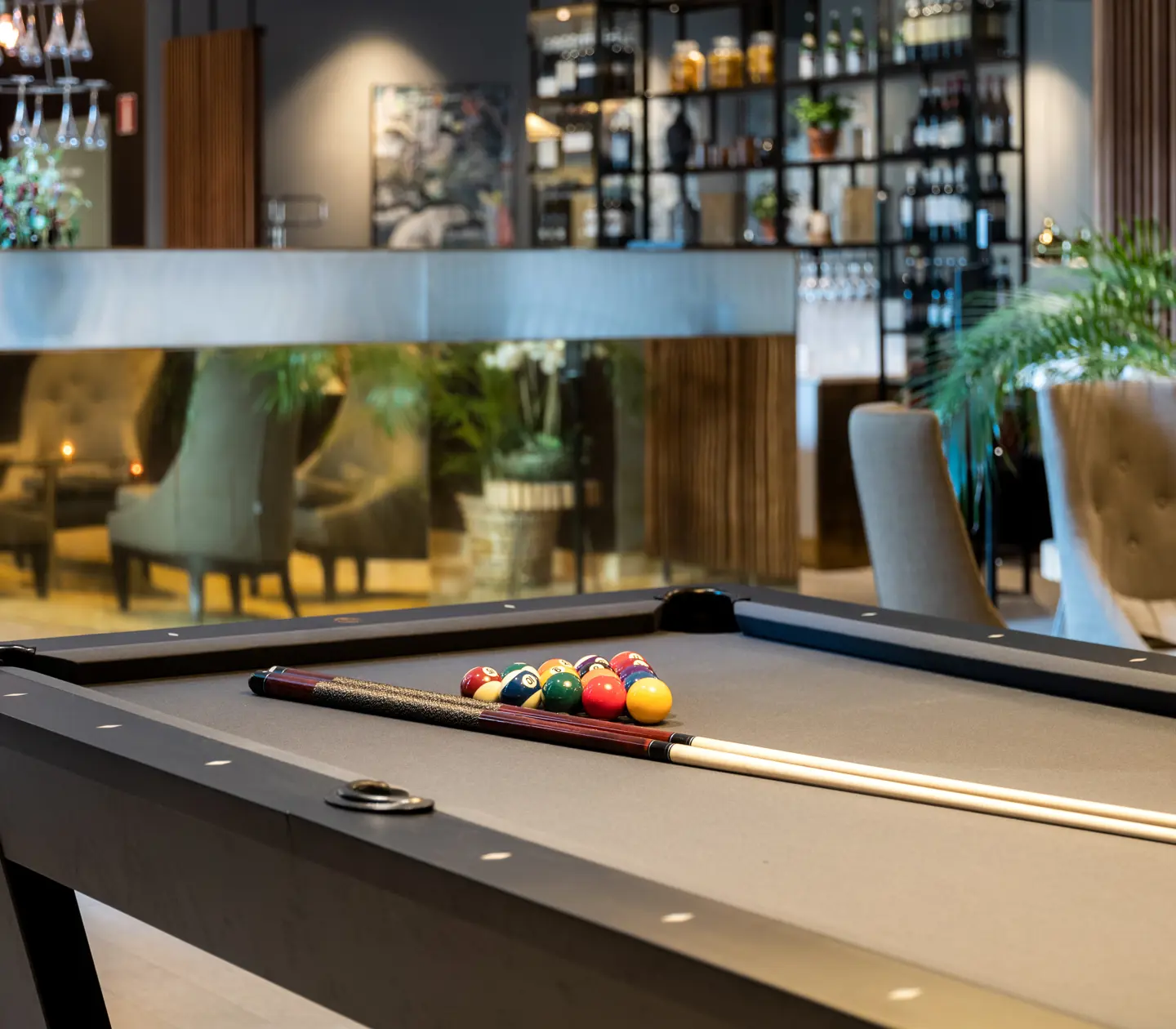 Pool table with bar in the background