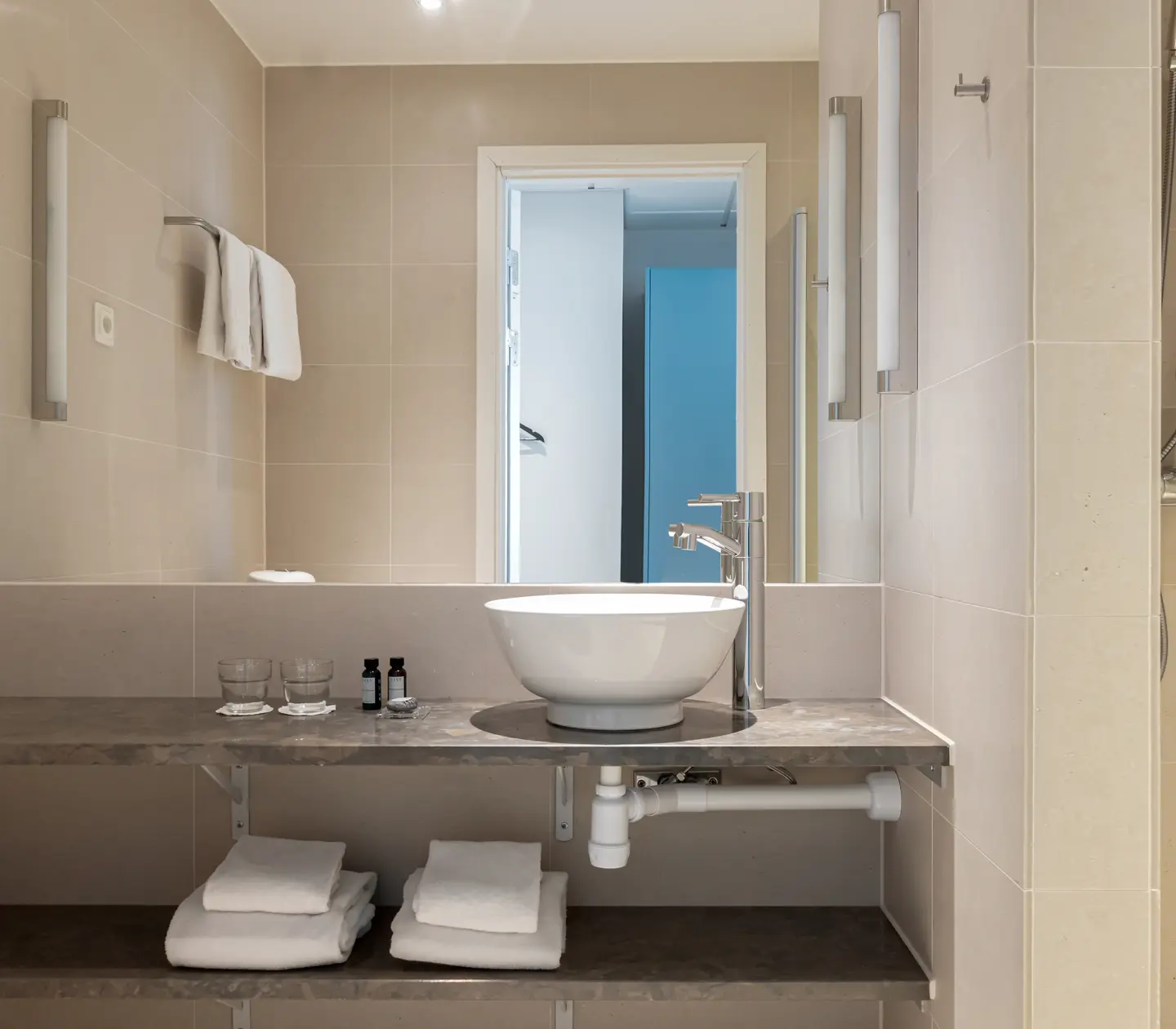 Bright bathroom with sink, towel and mirror