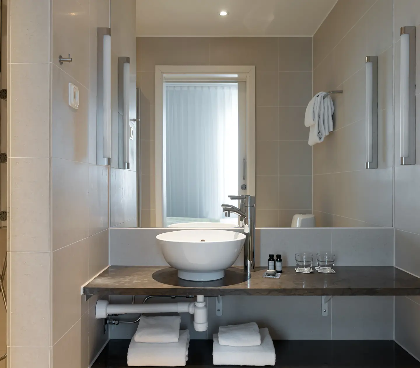 Beige bathroom with sink, mirror and shower