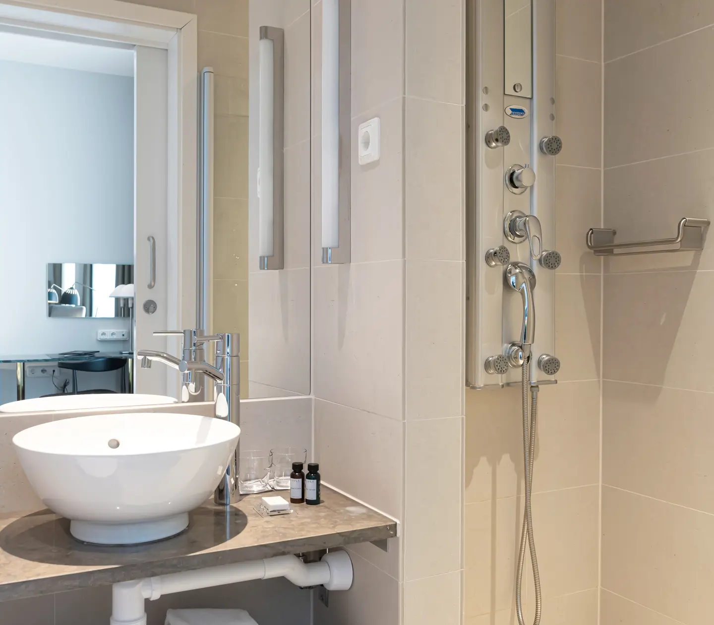 Beige bathroom with sink, mirror and shower