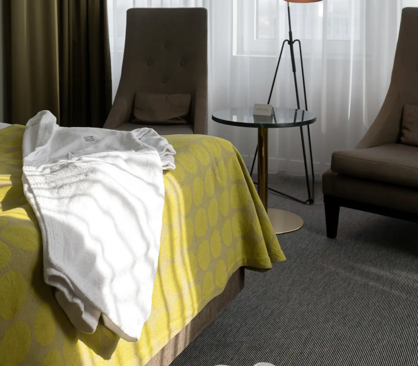 Bed with bathrobe, armchairs and table