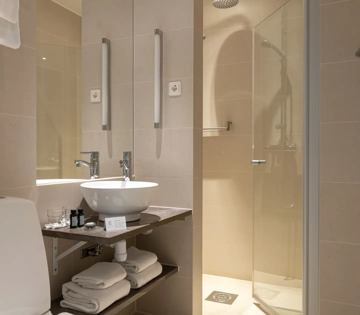 Beige bathroom with sink, mirror and toilet