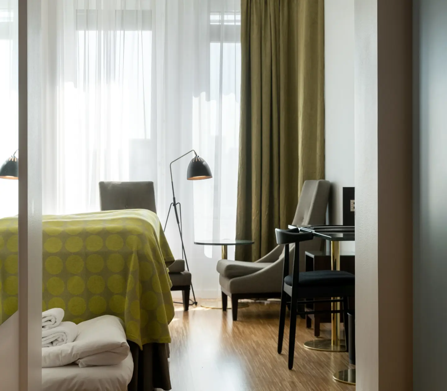 Hotel room with bed, armchairs and window