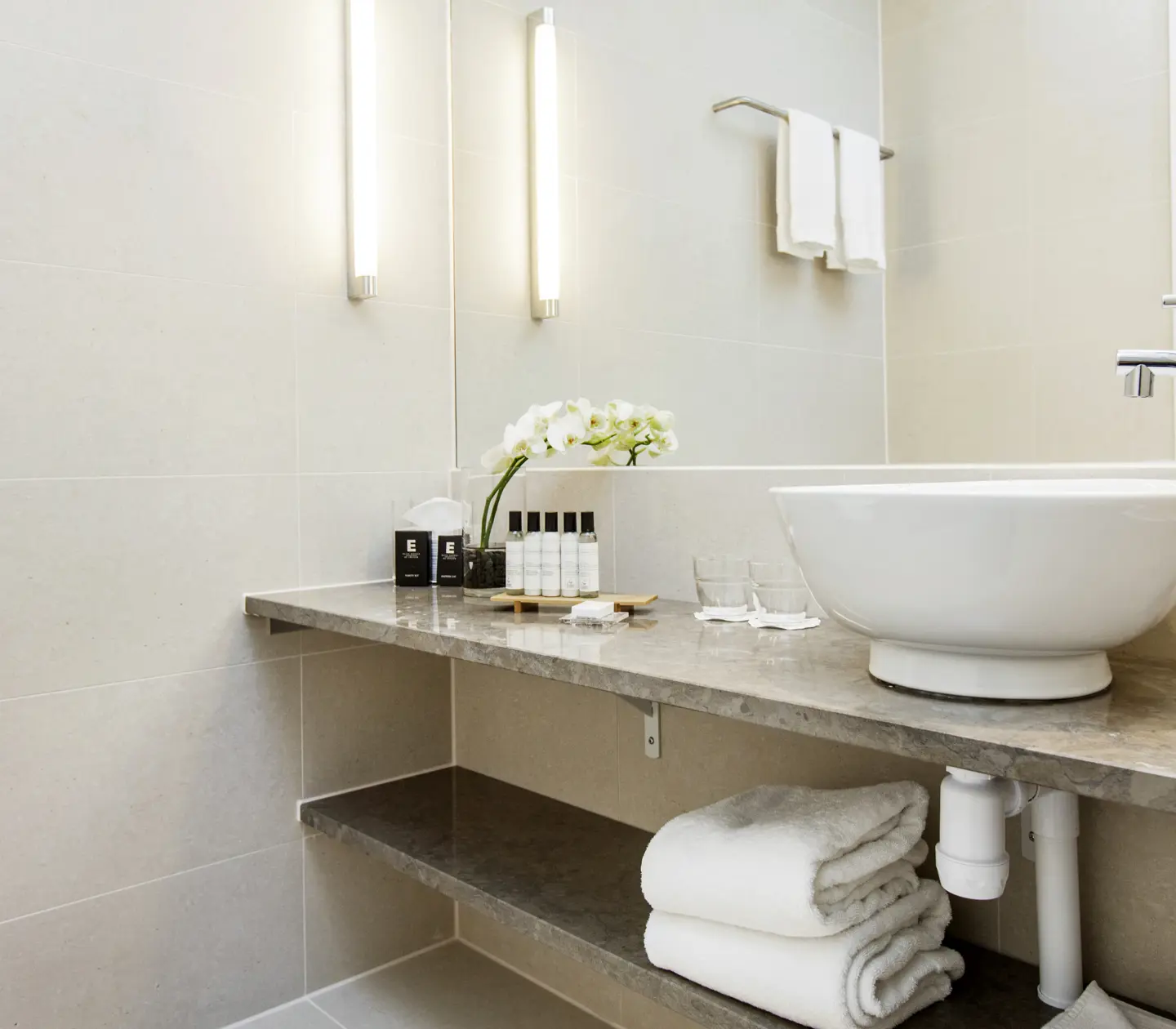Beige bathroom with sink, mirror and toilet
