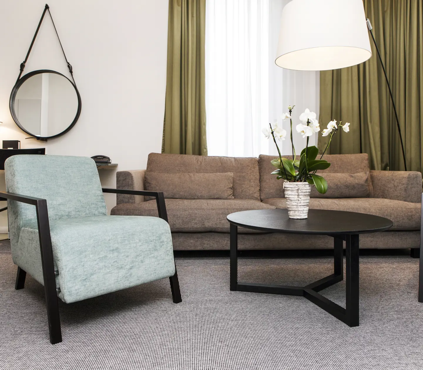 Bright suite with desk, sofa group and window