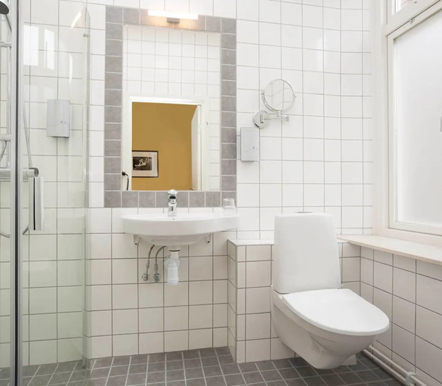Bright bathroom with shower, toilet and sink