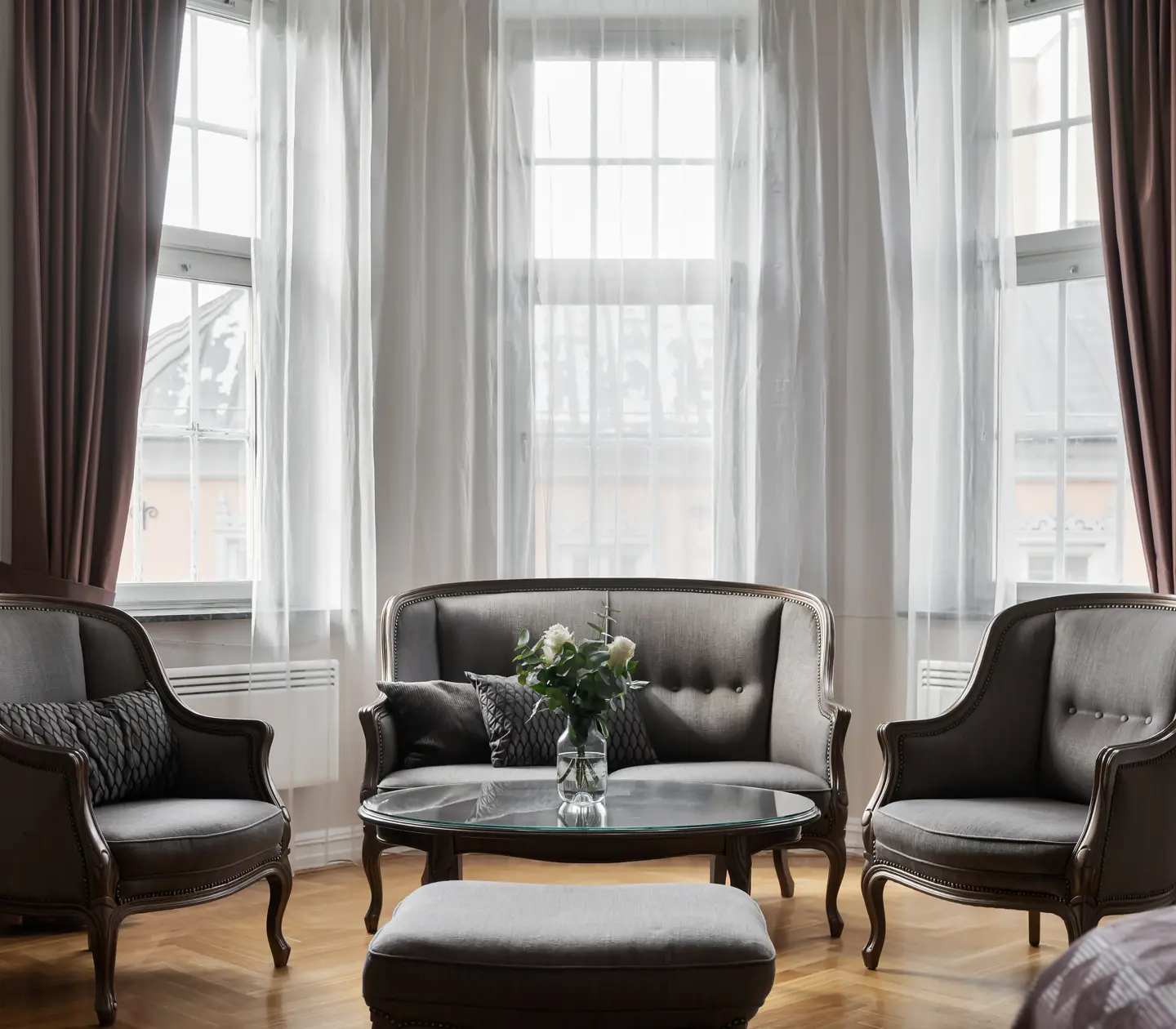 Hotel room with sofa group and large windows