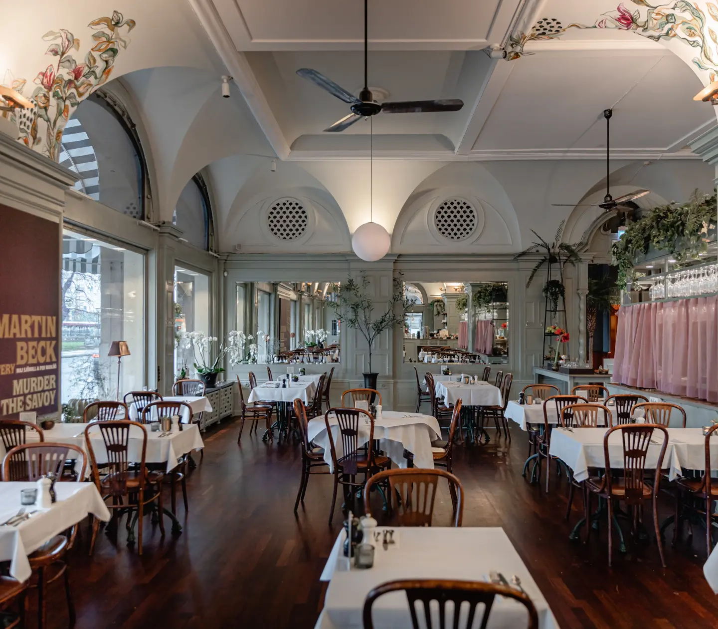 Stylish venue with wall and ceiling paintings and many table groups