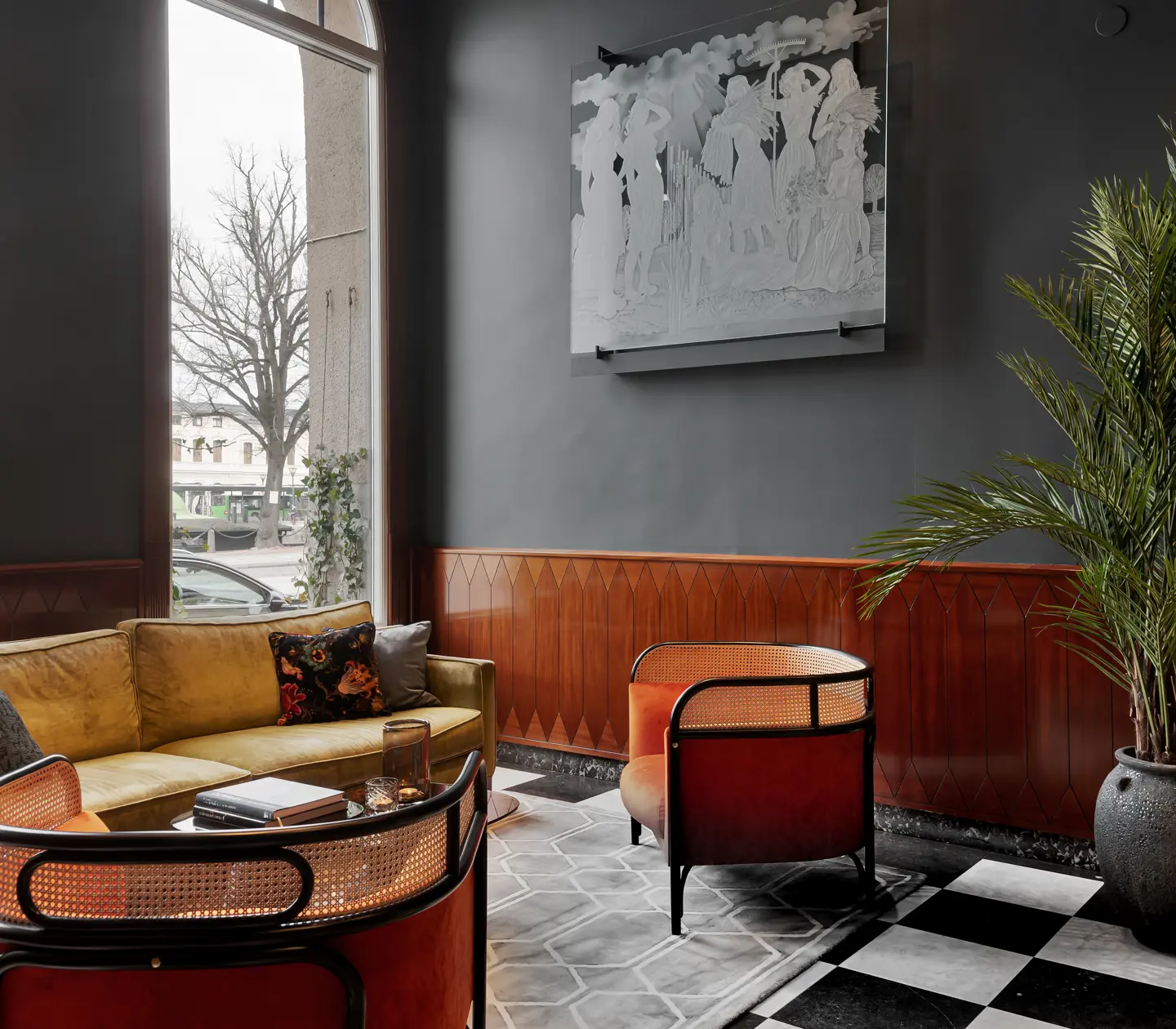 Nice hotel lobby with sofa group, potted plants and windows
