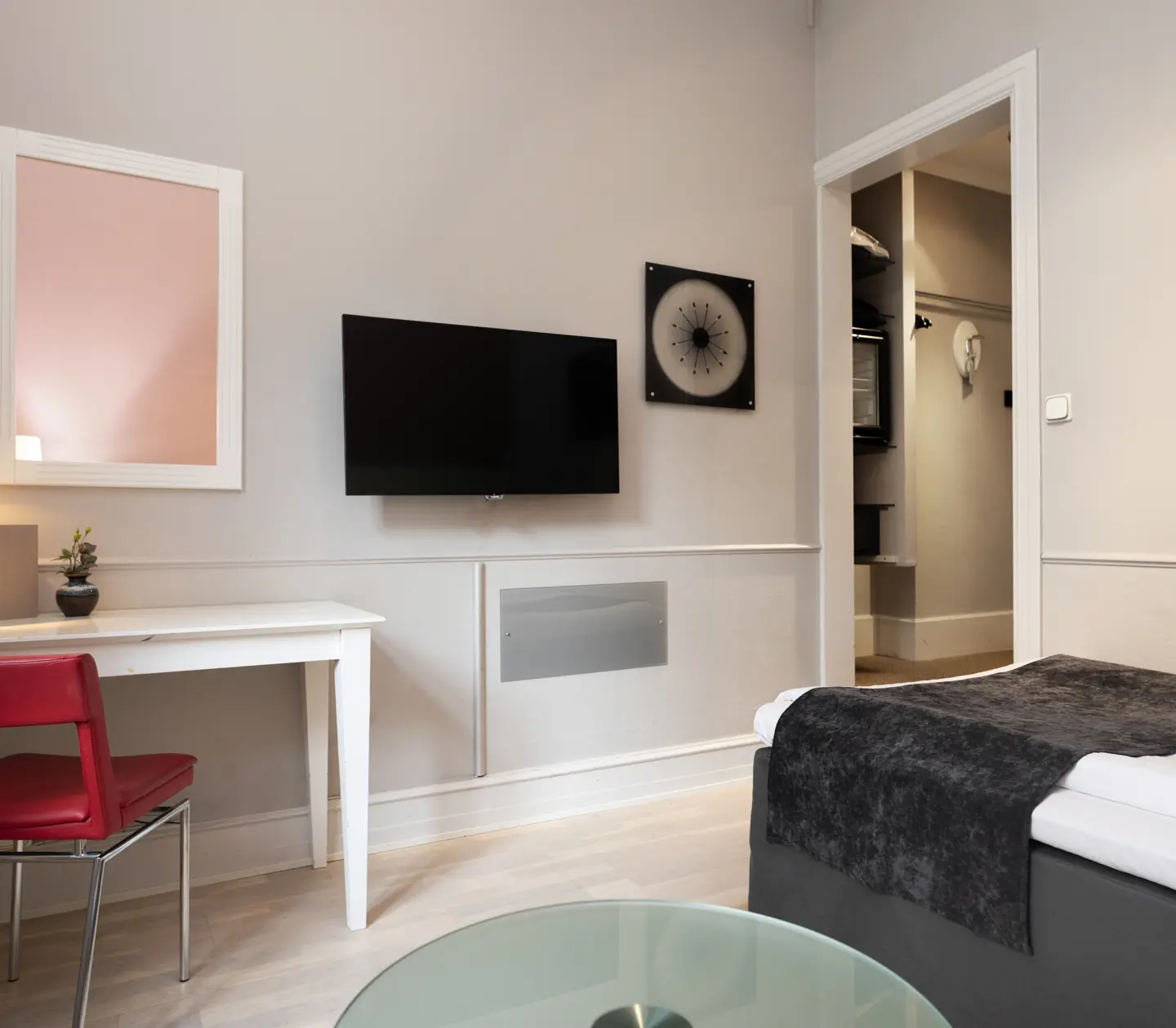 Hotel room with single bed, desk and TV