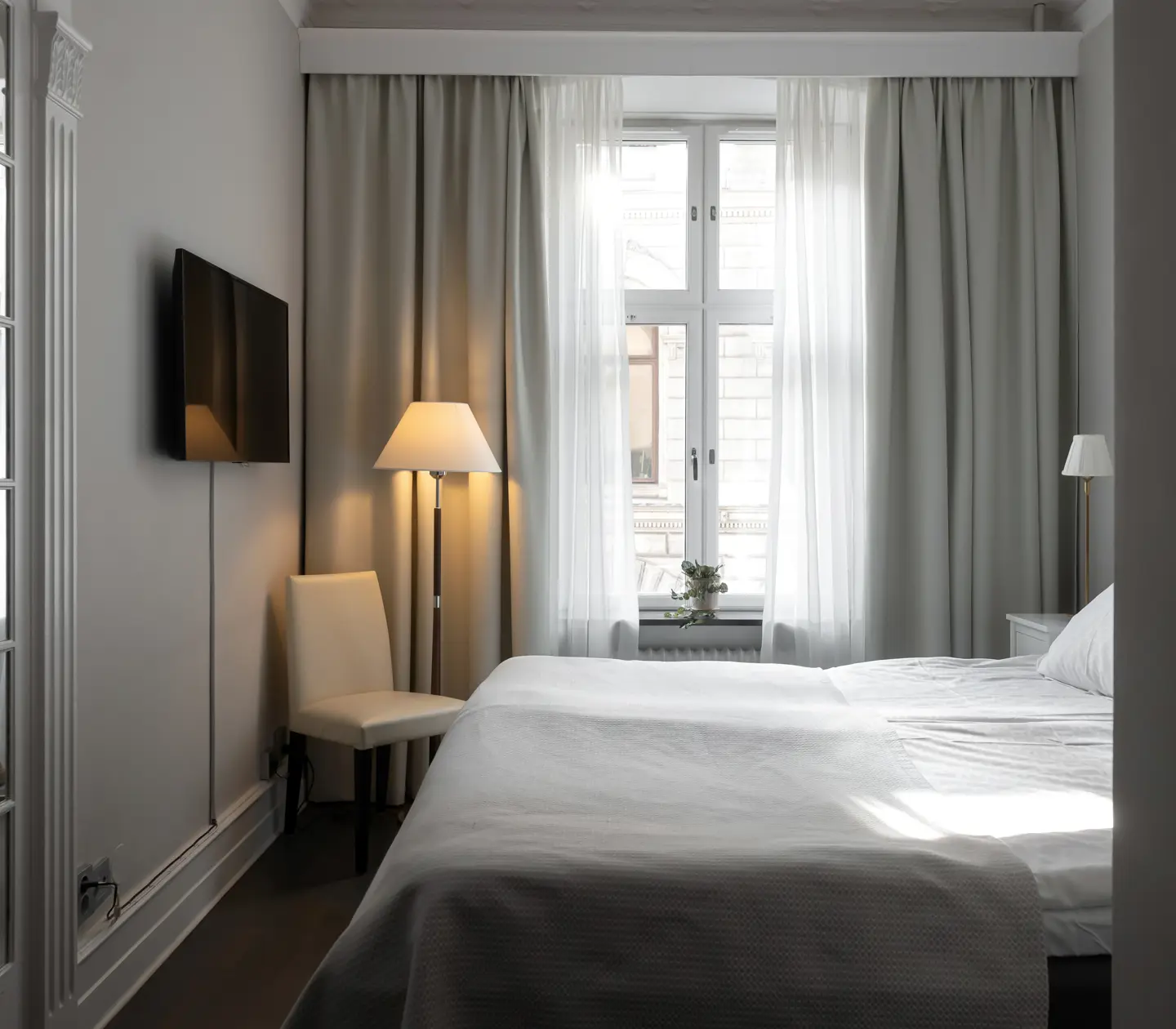 Hotel room with double bed, mirror and window